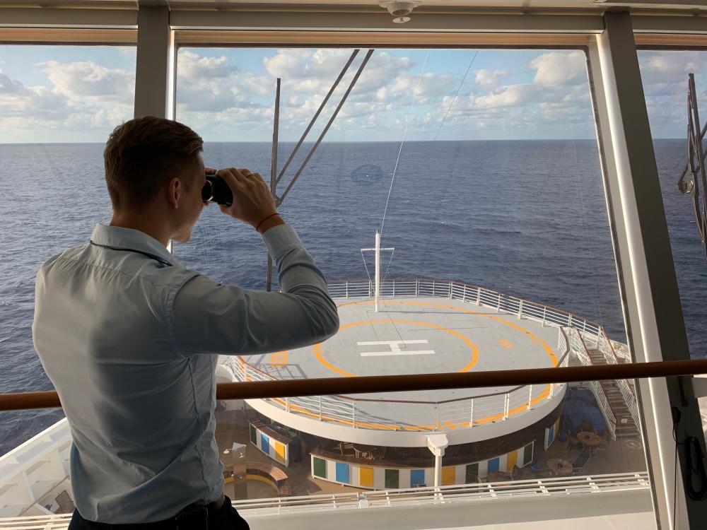 Captain watching out with binoculars