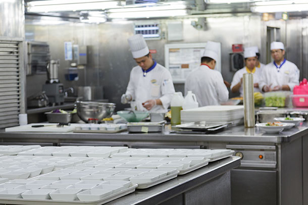 Four Cruise ship chefs working in a kitchen